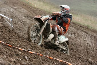 bikers slide in the mud on the slope